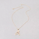 Złoty naszyjnik z zawieszką z dziewczynką na rowerze. NA SZOSĘ