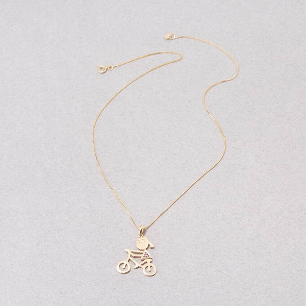 Złoty naszyjnik z zawieszką z dziewczynką na rowerze. NA SZOSĘ