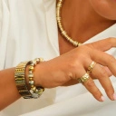 Bransoletka z inkrustowanych i pozłacanych ogniw ze stali. PHILHARMONIE