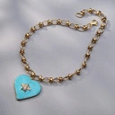 Pozłacany wisior z błękitnym sercem z muszką z cyrkonii. LECĘ BO CHCĘ