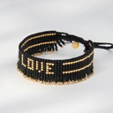 Bransoletka z czarnych paciorków Miyuki ze złotym napisem. CZUŁOŚCI W CIEMNOŚCI