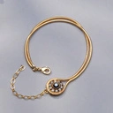 Złocona bransoletka na żmijce z oczkiem z czarnymi kryształami. CZERŃ I KLASYKA