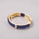 Sztywna złota bransoletka z granatowym paskiem. NOCHE CLARA