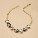 Krótki pozłacany naszyjnik z szarymi kryształami. MARTINI