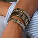 Bransoletka z inkrustowanych i pozłacanych ogniw ze stali. SAINT GERMAIN