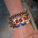 Sztywna złocona bransoletka zdobiona niebieskim akrylem. DROGA ŻYCIA