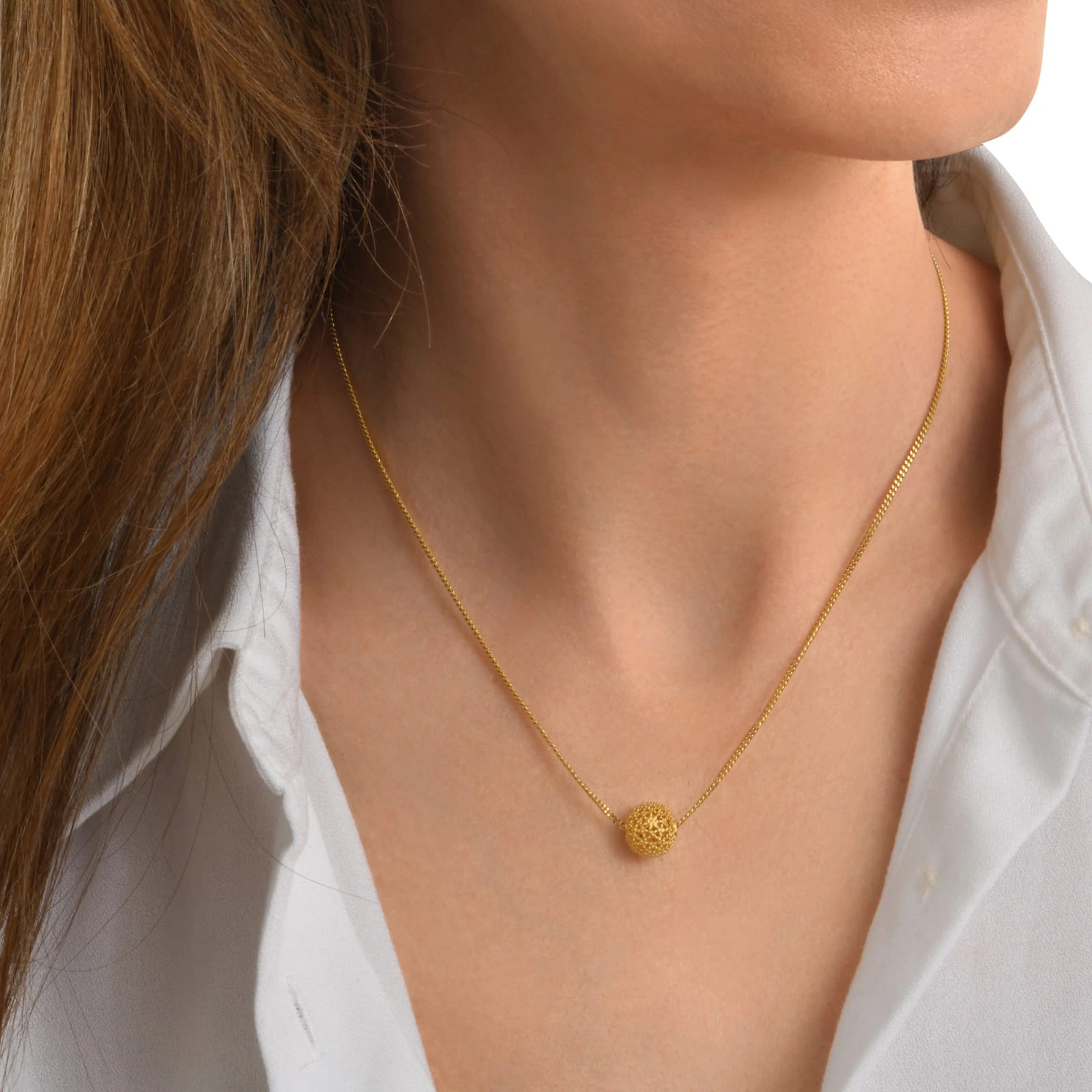 Pozłacany naszyjnik z ażurowym kulistym dekorem. ODDECH RIWIERY