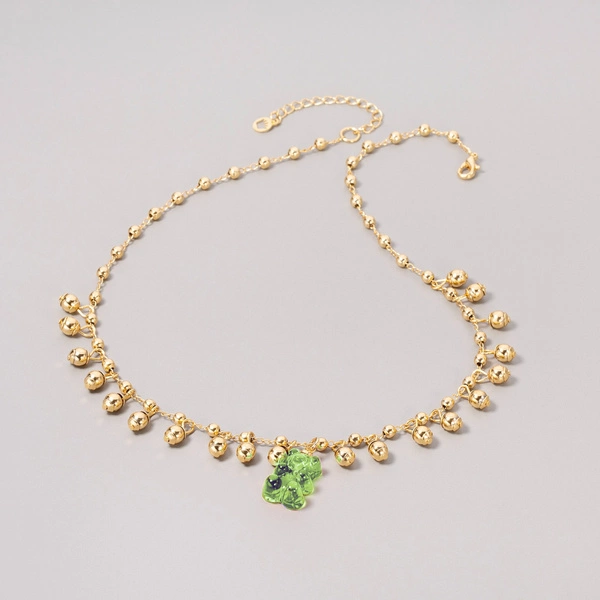 Złocony naszyjnik na łańcuszku z fosforyzującym misiem. MIŚTRZ CIEMNOŚCI