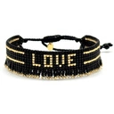 Bransoletka z czarnych paciorków Miyuki ze złotym napisem. CZUŁOŚCI W CIEMNOŚCI