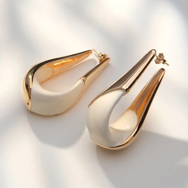 Złocone kolczyki w kształcie rogów z białą emalią. TAKI MÓJ UROK