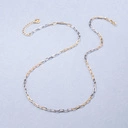 Naszyjnik z łączonych srebrnych i złotych łańcuchów. CZARNO NA BIAŁYM