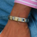 Bransoletka z inkrustowanych i pozłacanych ogniw ze stali. RUE DE RIVOLI