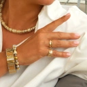 Bransoletka z inkrustowanych i pozłacanych ogniw ze stali. PHILHARMONIE