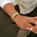 Pozłacana elastyczna bransoletka z ogniw ze stali. CHAMP ELYSSES