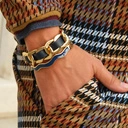 Sztywna złocona bransoletka zdobiona niebieskim akrylem. DROGA ŻYCIA