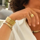 Pozłacana elastyczna bransoletka z ogniw ze stali. CHAMP ELYSSES