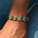 Bransoletka z inkrustowanych i pozłacanych ogniw ze stali. RUE DE RIVOLI