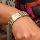 Bransoletka z inkrustowanych i pozłacanych ogniw ze stali. PHILHARMONIE