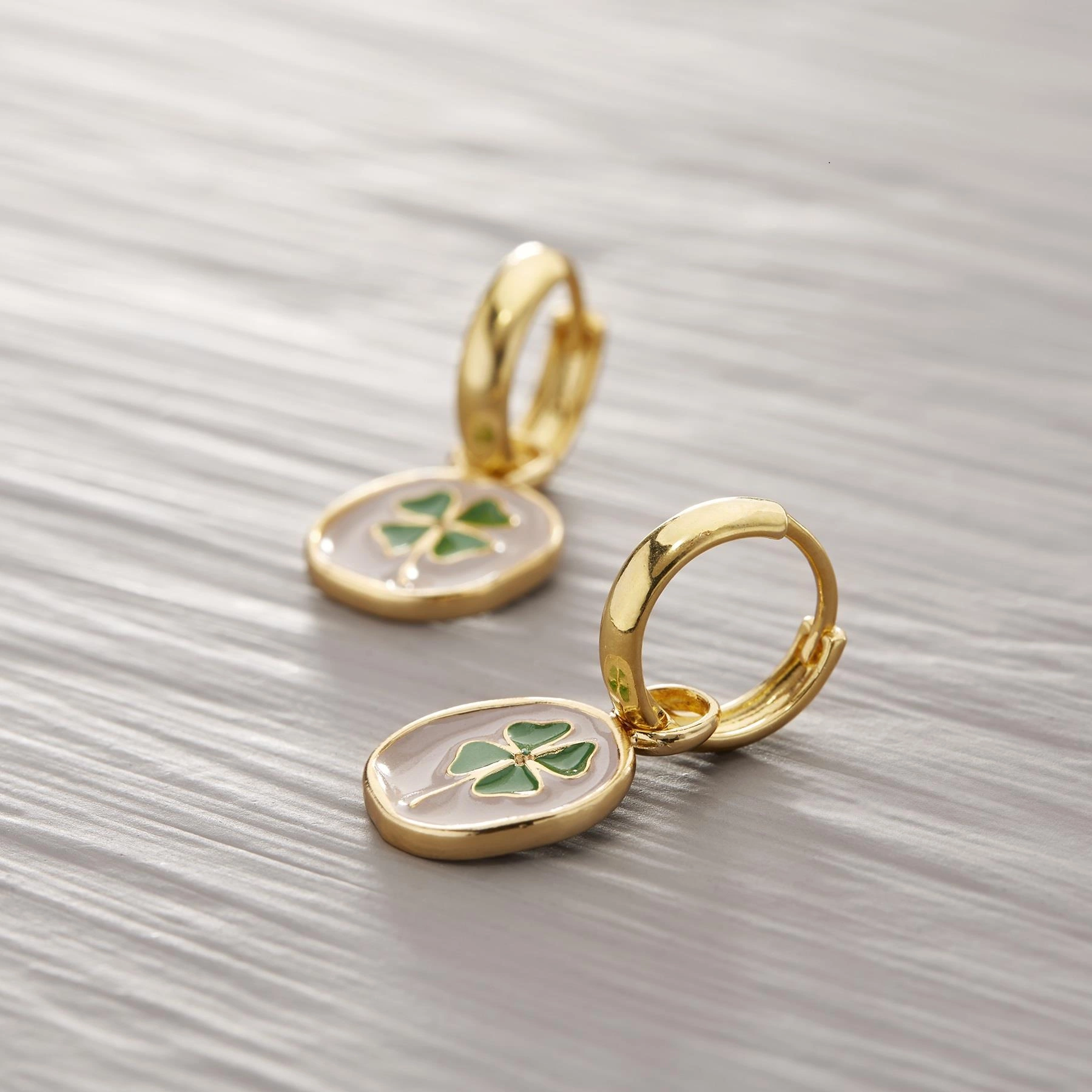 Pozłacane kolczyki z zawieszką z zieloną koniczynką. MAM SZCZĘŚCIE