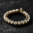 Pozłacana bransoletka z białych pereł w oprawach. CZARUJĄCO