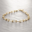 Krótki pozłacany naszyjnik z ogniw à la szekle. SPLOT TIFFANY'EGO