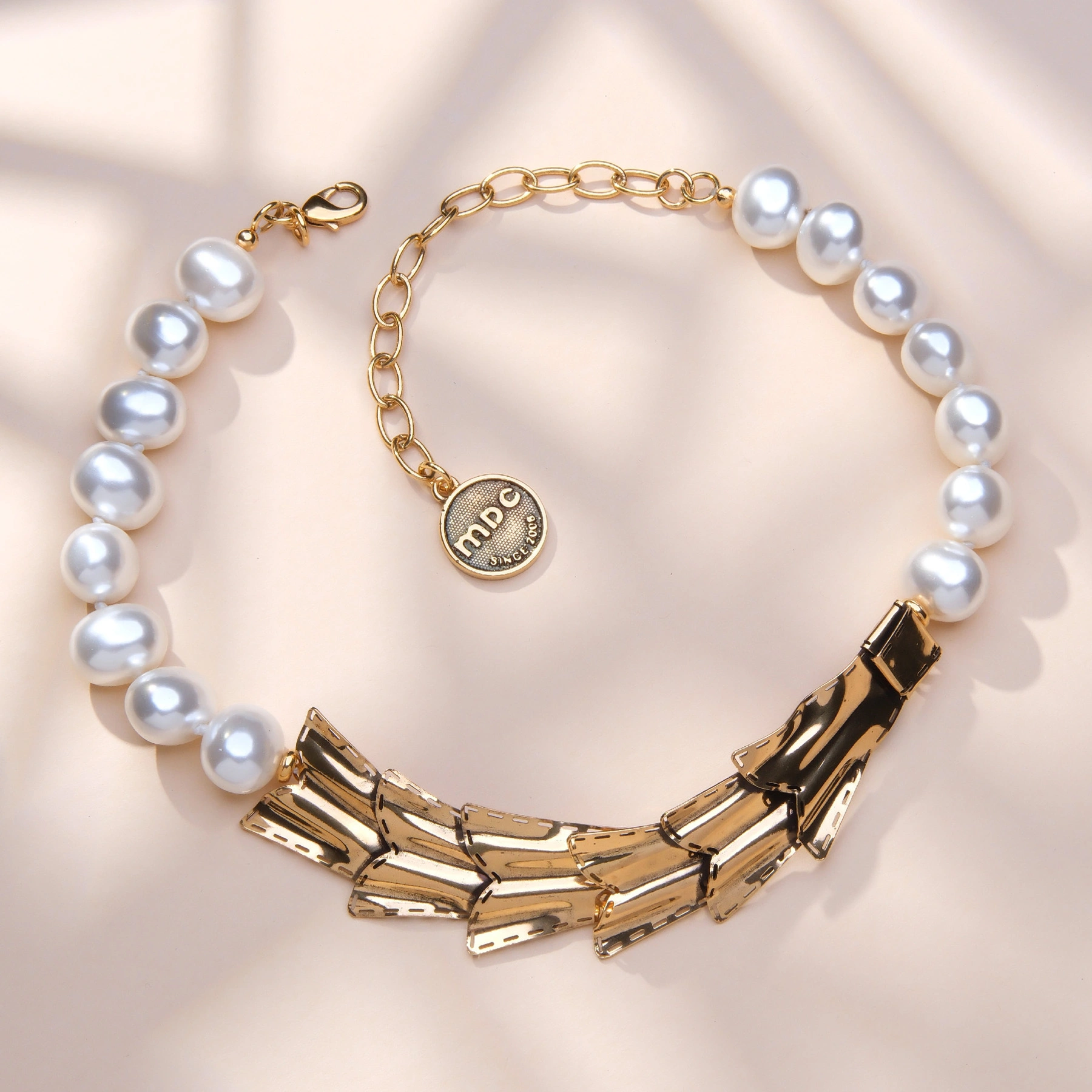 Złocony naszyjnik z pereł z teksturowanym dekorem. JEANNE