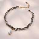 Krótki złocony naszyjnik z hematytami i perłą barokową. CABO DE SALOU