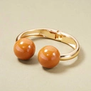 Złota sztywna bransoletka z kulkami w kolorze sieny. BRAZYLIJSKIE TRUFLE