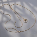 Złocony naszyjnik na żmijce z zielonym i białymi kryształami. STAŁA GRAWITACJI