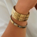 Pozłacana elastyczna bransoletka z ogniw ze stali. CHAMP ELYSSES
