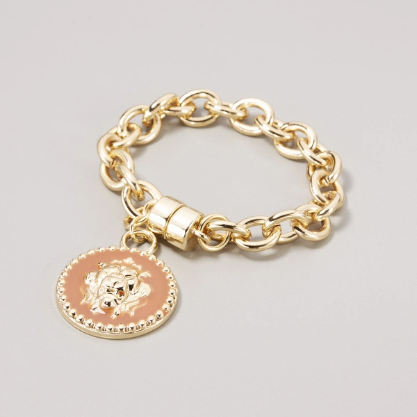 Pozłacana bransoletka łańcuch z ozdobnym medalionem. MACAW