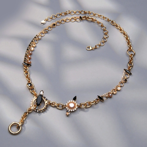 Złocony naszyjnik z białymi i czarnymi kryształkami. ZDECYDOWANA NA ZMIANĘ 