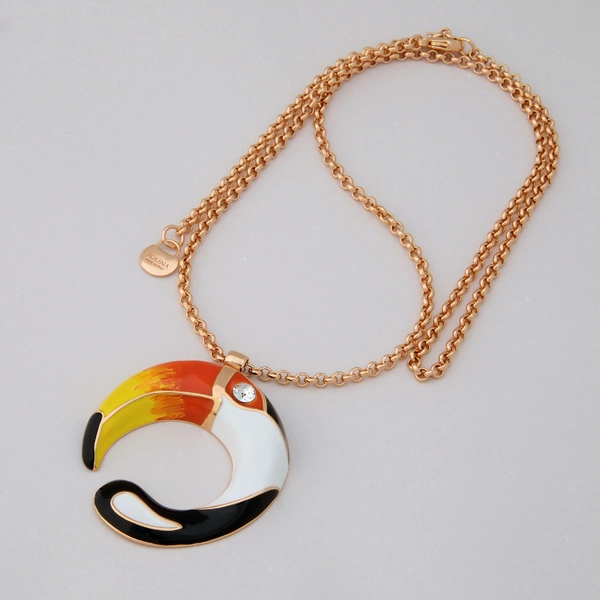 Pozłacany wisior z zawieszką z kolorowym tukanem. GŁOS TROPIKÓW