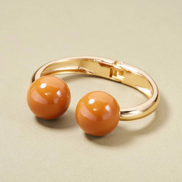 Złota sztywna bransoletka z kulkami w kolorze sieny. BRAZYLIJSKIE TRUFLE